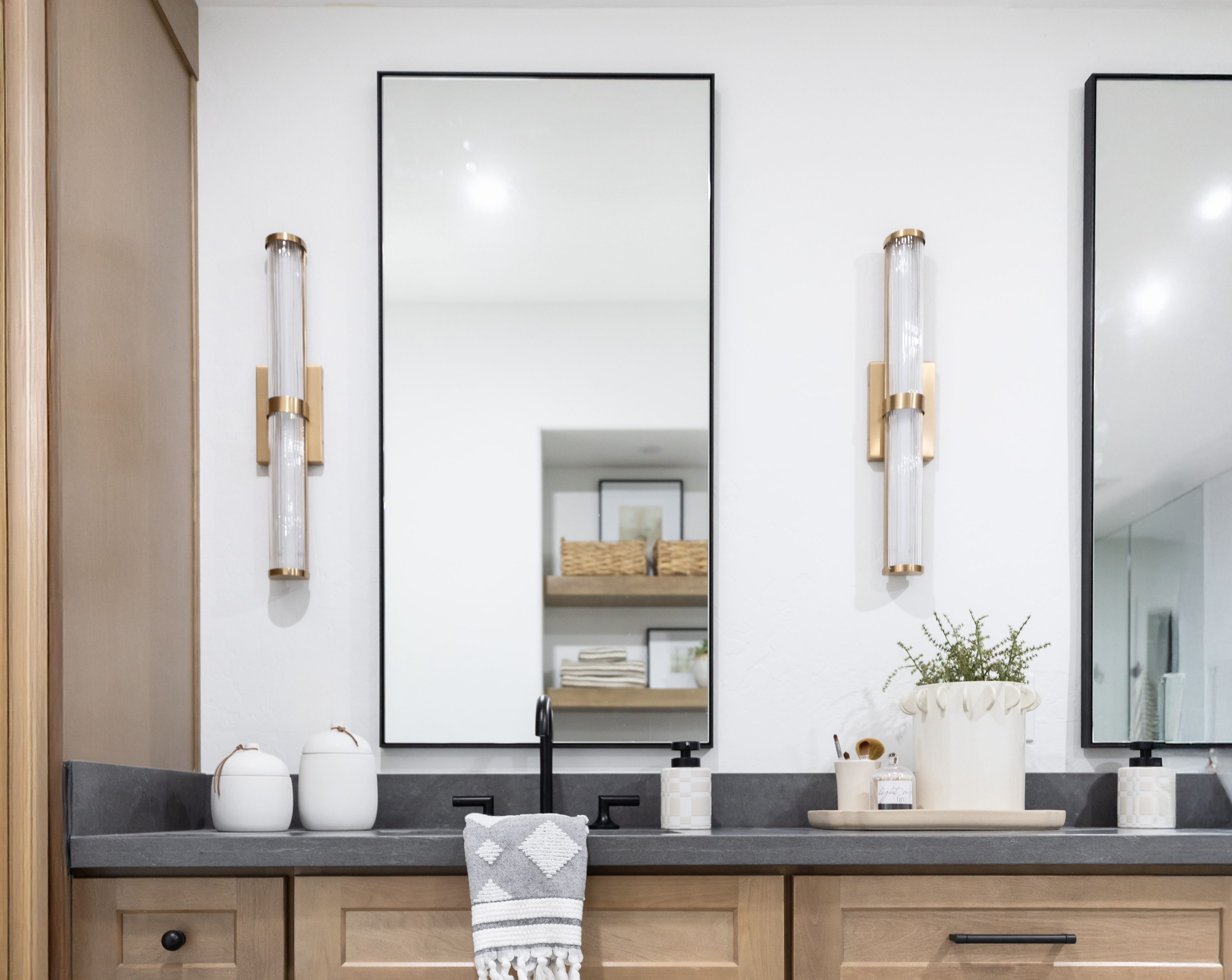 An image of a master bathroom with a large custom framed bathroom mirror.