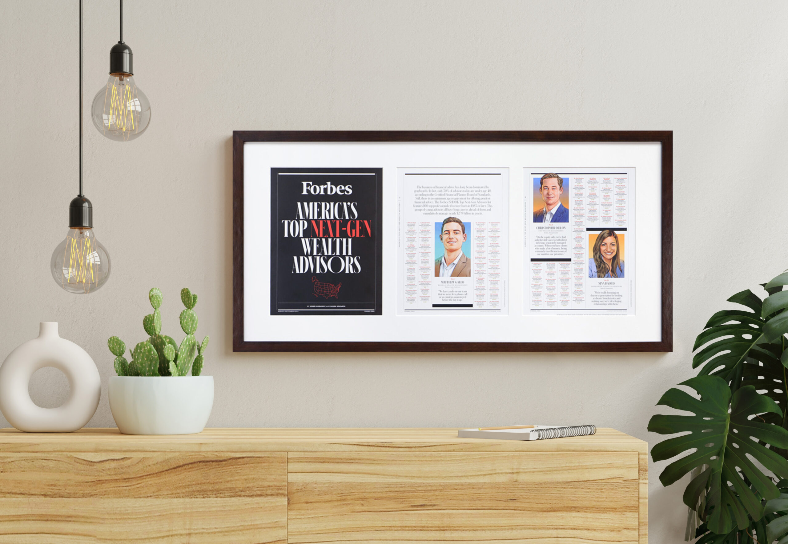 Wide dark wooden frame displaying three framed magazine pages, including a Forbes cover and feature articles, hanging on a neutral wall above a wooden sideboard.