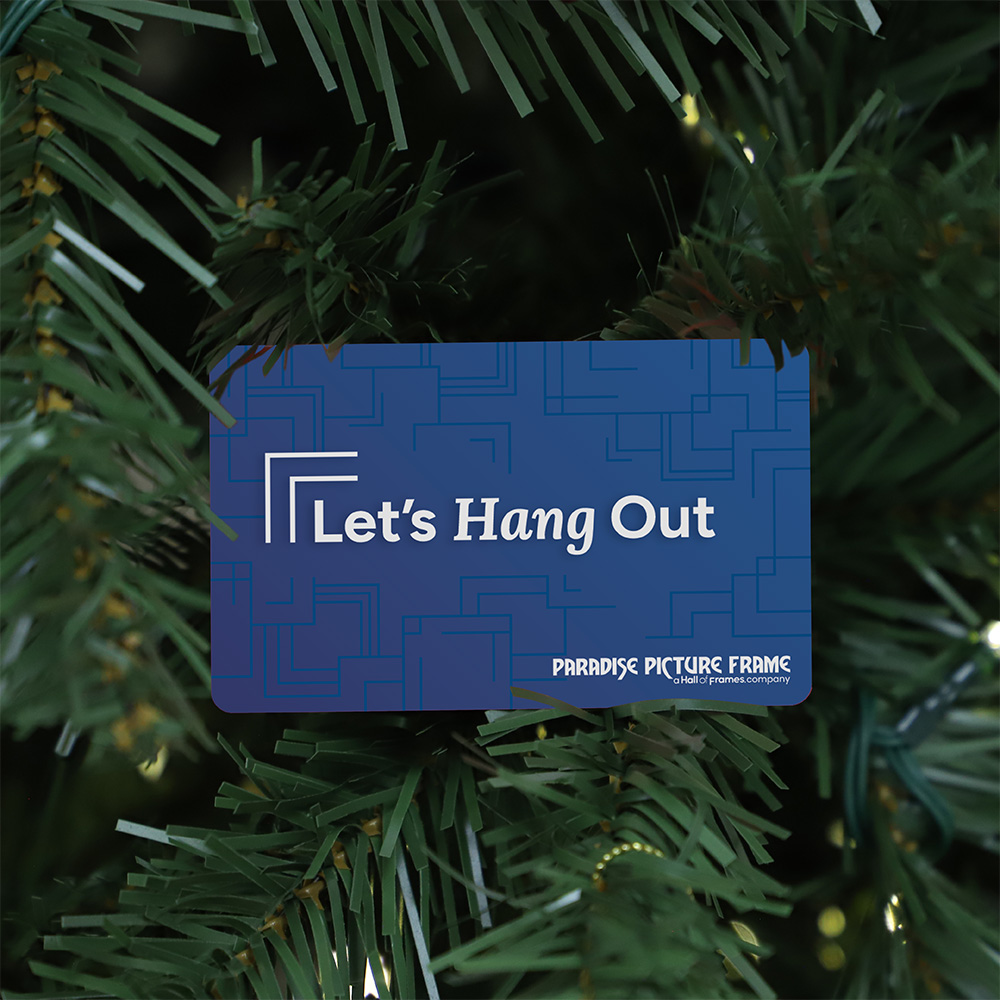 Blue Paradise Picture Frame gift card featuring the text "Let's Hang Out" nestled in the green branches of a Christmas tree.